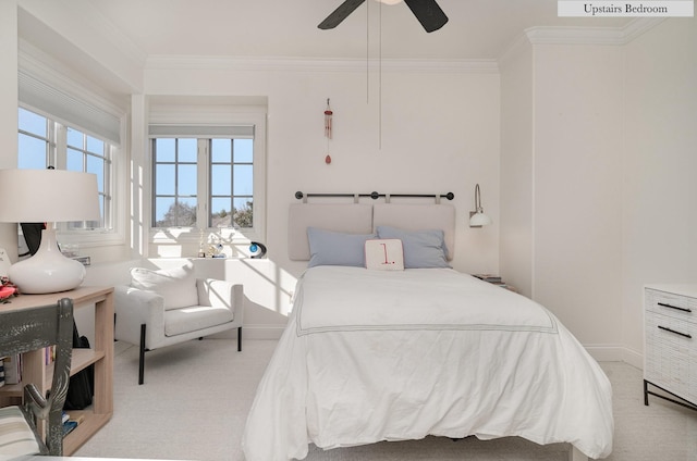 bedroom with light carpet, ceiling fan, and crown molding