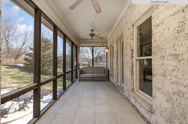 unfurnished sunroom with ceiling fan