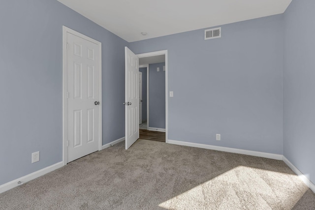 unfurnished bedroom featuring light carpet