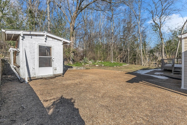 view of yard with a deck and a storage shed