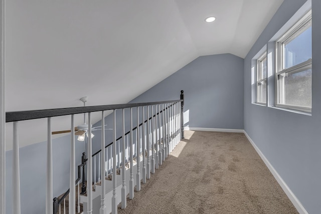 corridor featuring vaulted ceiling and carpet