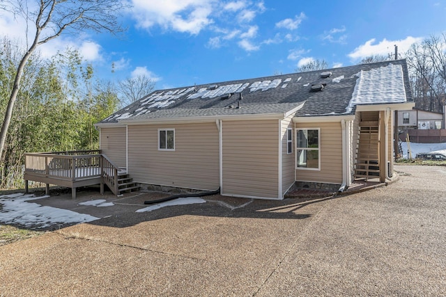 back of house with a wooden deck