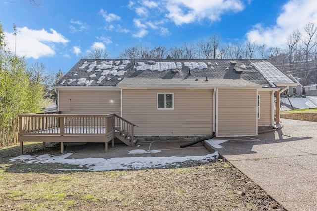 rear view of property with a wooden deck