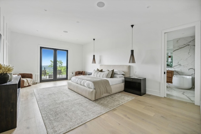 bedroom with french doors, access to outside, light hardwood / wood-style flooring, and ensuite bathroom