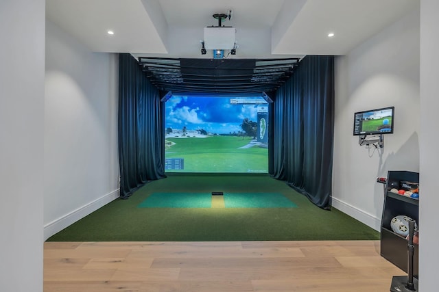 rec room with golf simulator and hardwood / wood-style flooring