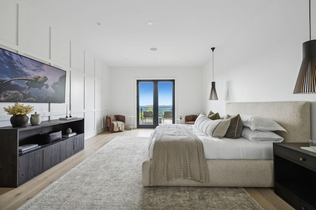 bedroom featuring access to outside and light hardwood / wood-style flooring