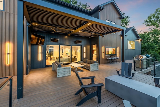 deck at dusk featuring an outdoor hangout area