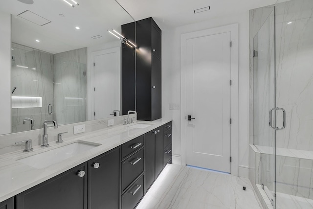 bathroom with vanity and a shower with shower door