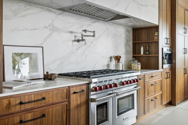 kitchen featuring decorative backsplash, range hood, and range with two ovens