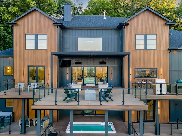 rear view of house featuring an outdoor hangout area