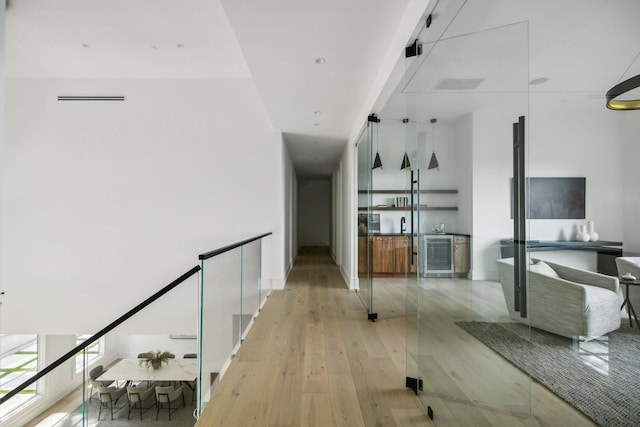 hallway with light hardwood / wood-style flooring