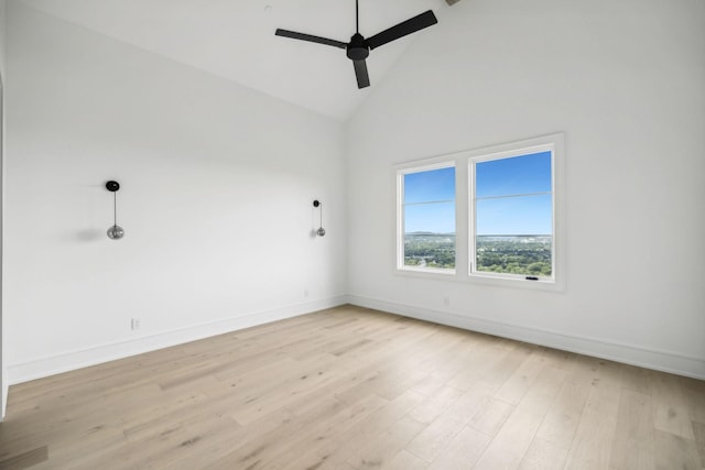 spare room with ceiling fan, high vaulted ceiling, and light hardwood / wood-style flooring