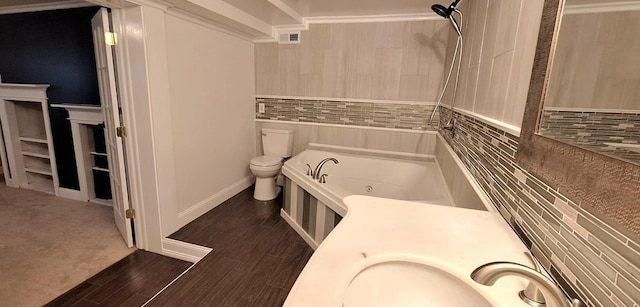 bathroom featuring a bathing tub, vanity, toilet, and wood-type flooring