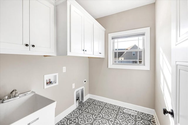 laundry room with cabinets, washer hookup, electric dryer hookup, and sink