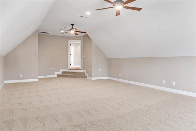 additional living space with light colored carpet, ceiling fan, and lofted ceiling