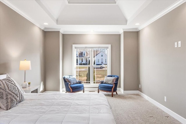 bedroom with a tray ceiling, crown molding, and carpet flooring