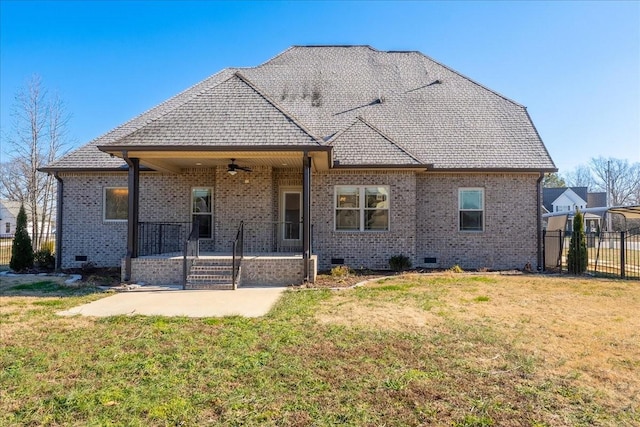 rear view of property with a lawn, a patio area, and ceiling fan