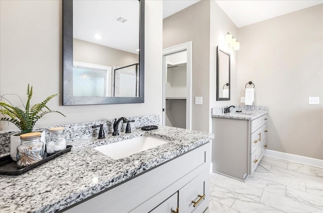 bathroom featuring a shower and vanity