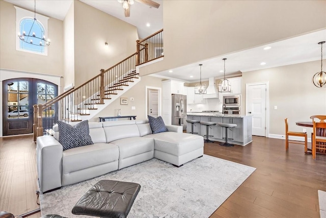 living room with wood-type flooring and a high ceiling