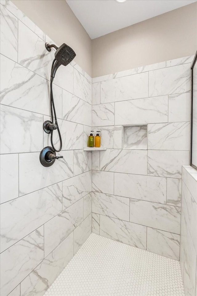 bathroom with a tile shower