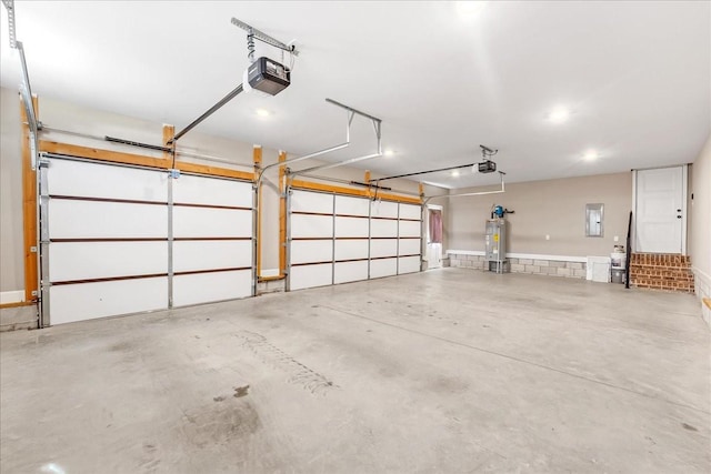 garage with electric panel, a garage door opener, and water heater