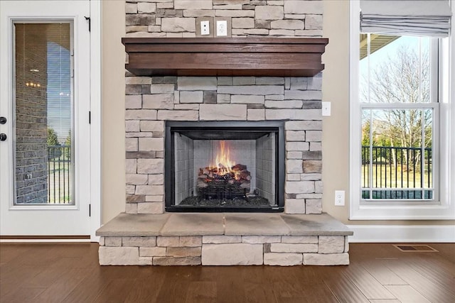 room details featuring a fireplace and hardwood / wood-style flooring