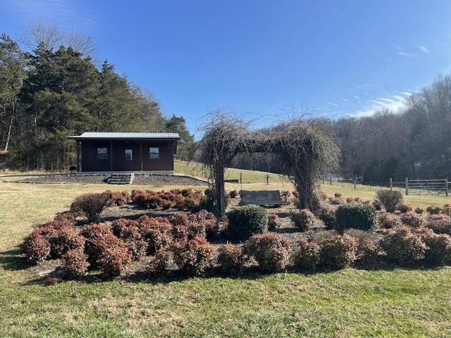 view of yard with an outdoor structure and a rural view