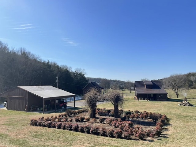 view of yard with an outbuilding and a rural view