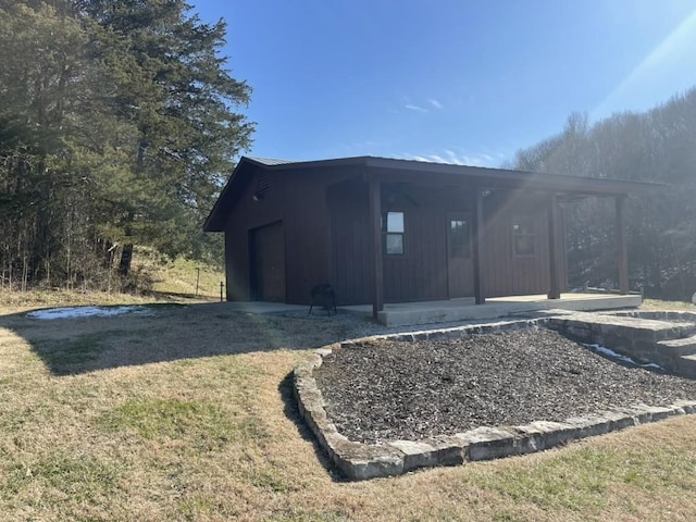 view of outbuilding featuring a yard