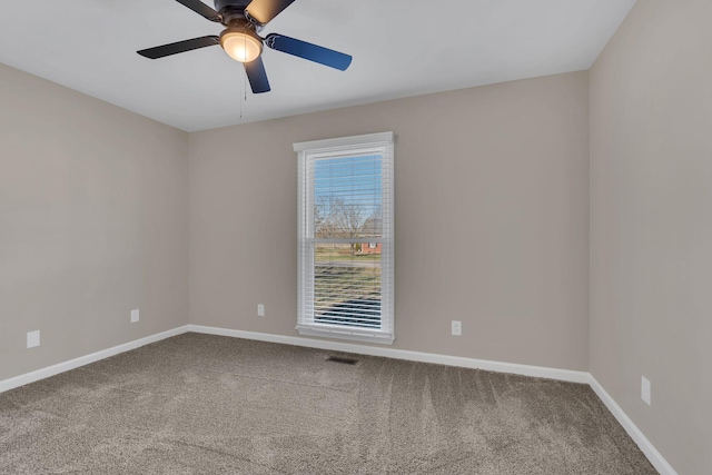 carpeted spare room with ceiling fan