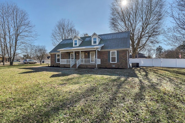 cape cod-style house with covered porch, central AC unit, and a front lawn