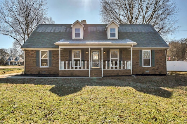 cape cod home with a porch and a front lawn