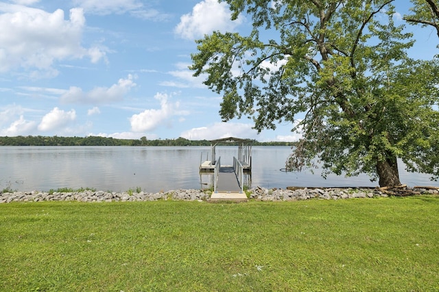 view of dock featuring a lawn and a water view