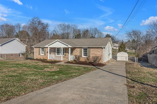 ranch-style house with a porch, a front lawn, an outdoor structure, and a garage