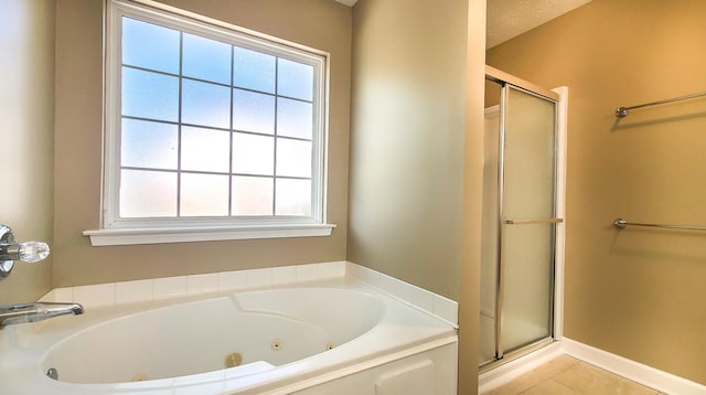 bathroom with tile patterned flooring, plus walk in shower, and a wealth of natural light