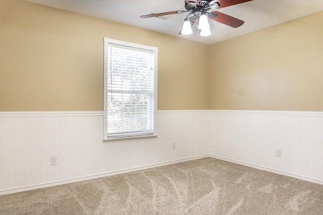 unfurnished room with carpet floors, plenty of natural light, and ceiling fan