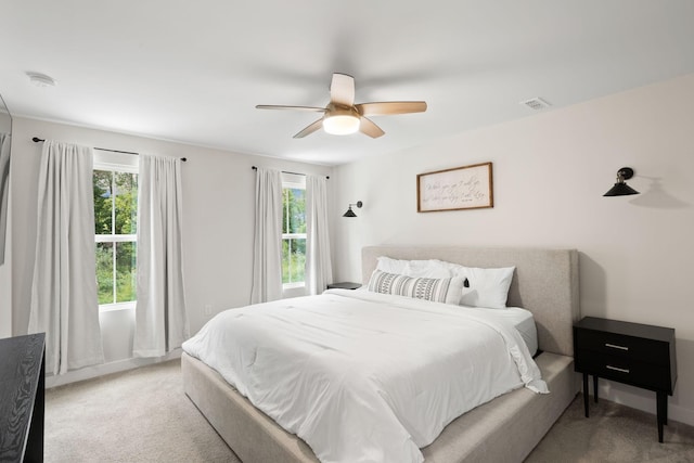 bedroom with ceiling fan and light colored carpet