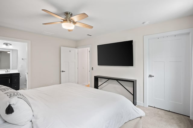 carpeted bedroom featuring ceiling fan, sink, and ensuite bathroom