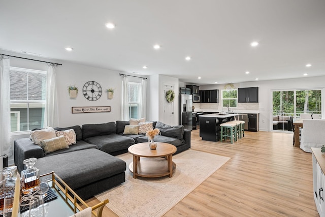 living room with sink and light wood-type flooring