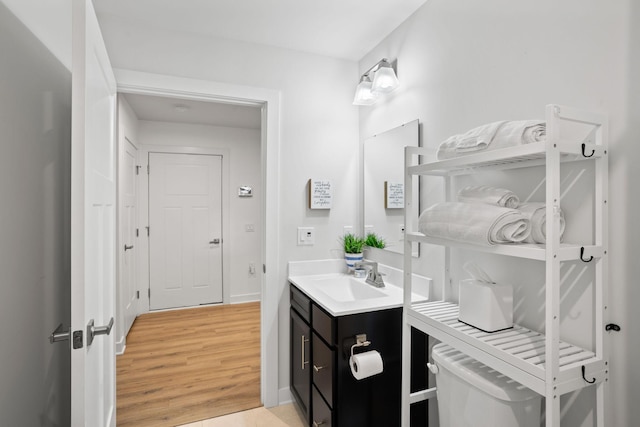 bathroom with vanity, wood-type flooring, and toilet