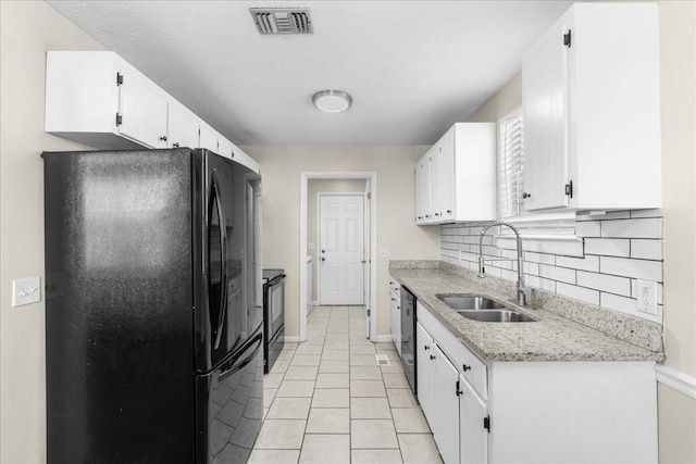 kitchen featuring sink, white cabinets, and black appliances