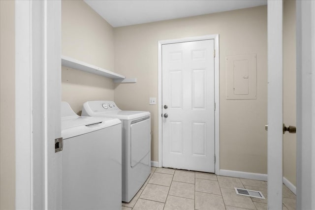 washroom featuring light tile patterned floors, electric panel, and separate washer and dryer