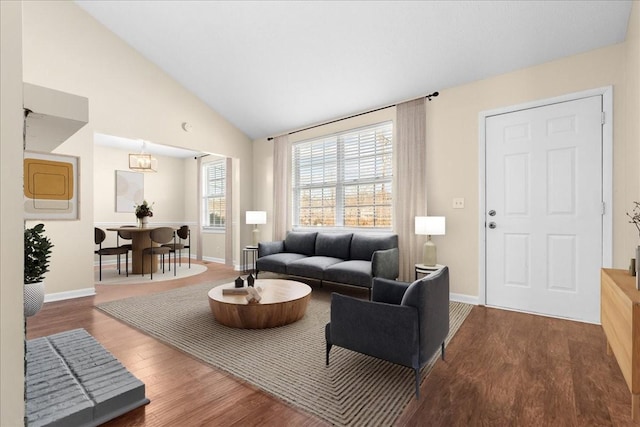 living room featuring hardwood / wood-style floors and vaulted ceiling