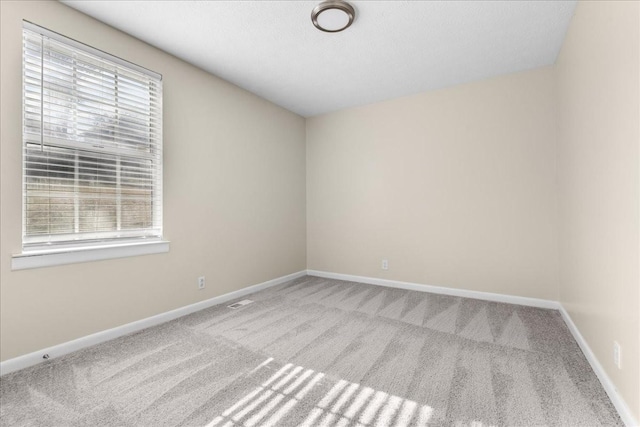 spare room with light carpet