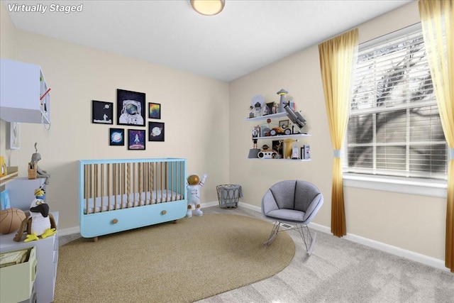 bedroom featuring a crib and light carpet