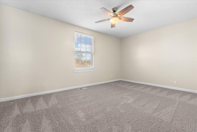 carpeted empty room featuring ceiling fan and a textured ceiling