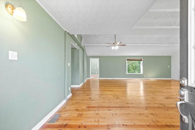 unfurnished room with ceiling fan and wood-type flooring