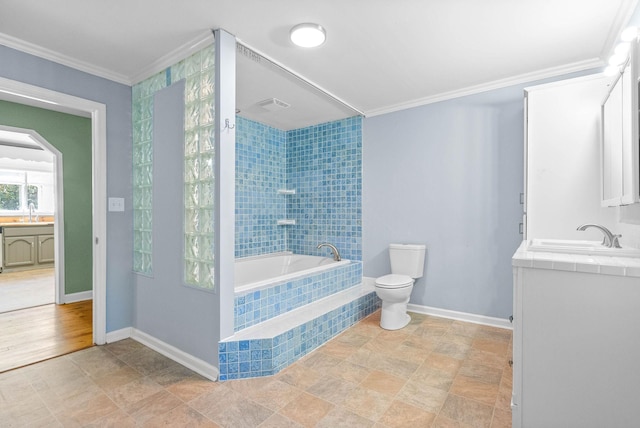 bathroom featuring a relaxing tiled tub, toilet, crown molding, and vanity