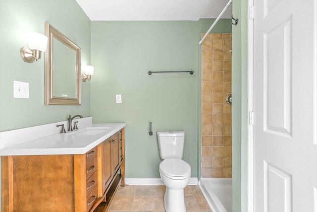 bathroom featuring vanity, toilet, and tiled shower