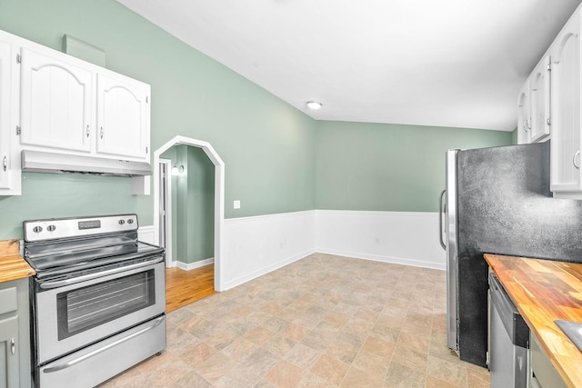 kitchen featuring butcher block countertops, white cabinetry, and stainless steel appliances